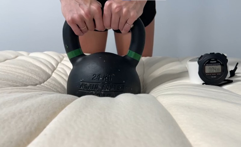 Our tester doing a response test on a Birch Luxe Natural Mattress