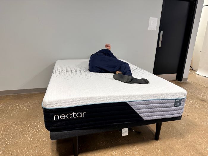 A man lies on his side on the Nectar Premier mattress
