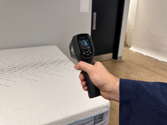 A temperature gun pointed at the Nectar Premier mattress with a reading of 71.8