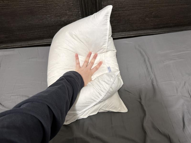 Our tester fold the Helix Down Pillow in half to assess the floofiness.