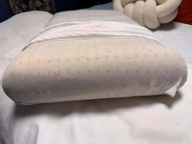 Peeling back the cover of a Helix GlacioTex Cooling Memory Foam Pillow