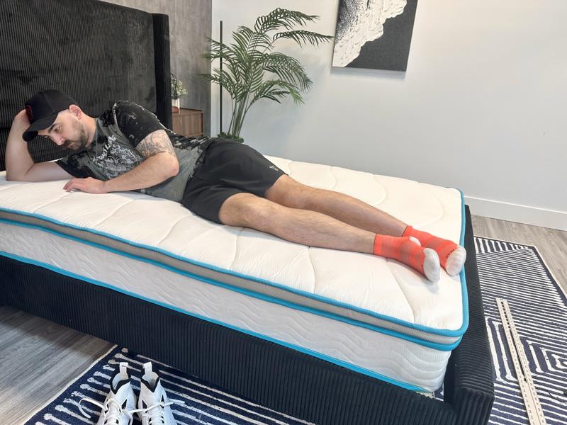 Our tester side-sleeping on the Linenspa 8-inch Hybrid Mattress