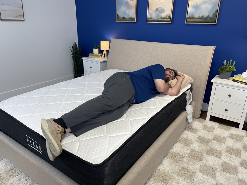 Our heavyweight tester rests on his side on the Plank Firm Luxe.