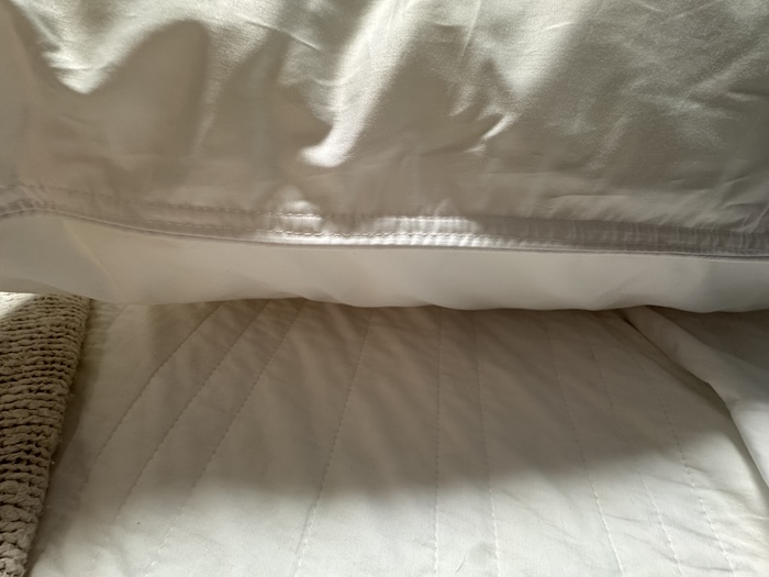 A closeup of the hem of the Peacock Alley Down Alternative Pillow.