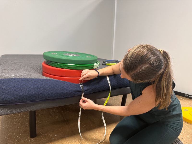Our product tester conducts a weighted edge support test of the DreamFoam 6-inch Essential Mattress
