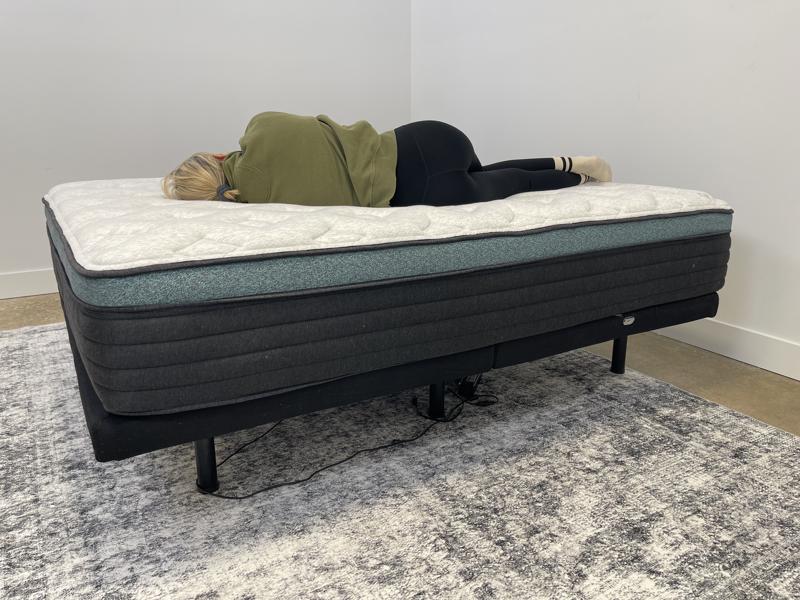 Our tester side-sleeping on the Helix Sunset Luxe Mattress