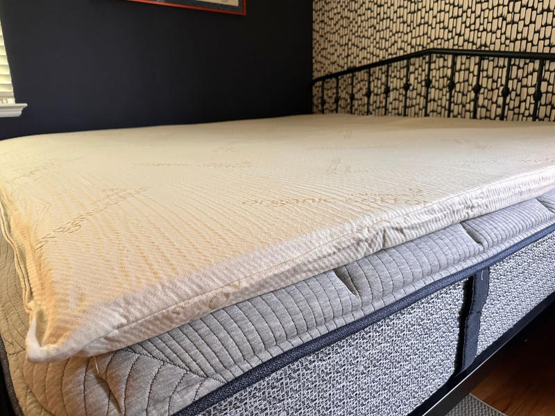 The Naturepedic 2-inch Adagio Organic Latex Mattress Topper on a bed in our tester's home.