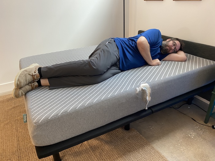 A man lying on his side on the Leesa Original mattress.