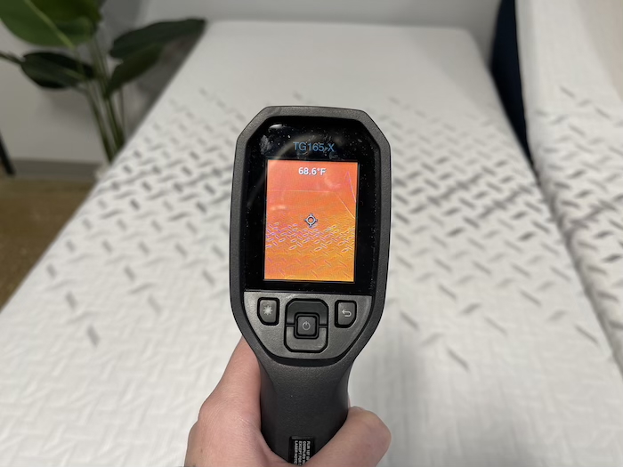 A closeup of a thermal gun reading the temperature of the Nectar Premier mattress at a neutral temperature. The screen reads 68.6 degrees.