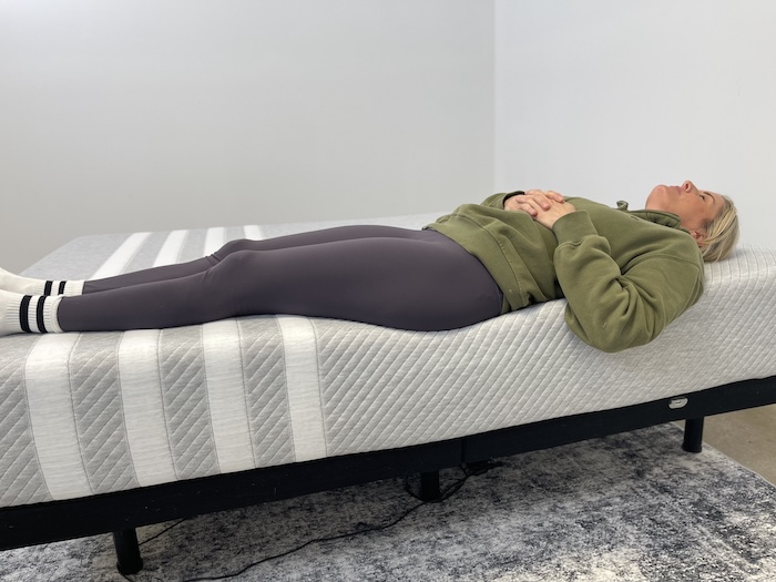 A woman sleeping on her back on the Leesa Original mattress.