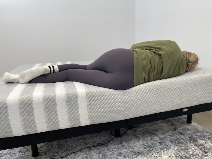 A woman sleeping on her side on the Leesa Original mattress.