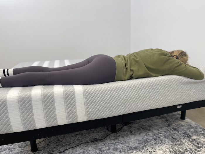 A woman sleeping on her stomach on the Leesa Original mattress.