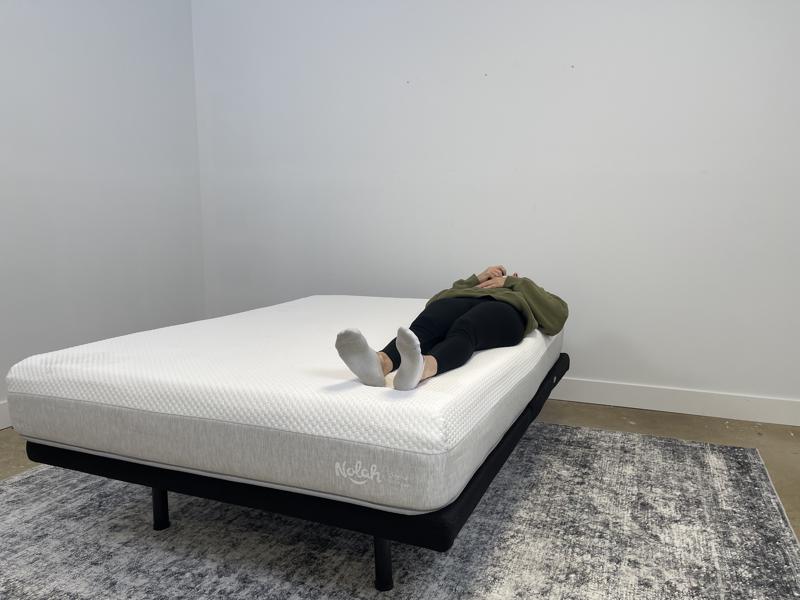Our tester back-sleeping on the Nolah Original AF Mattress