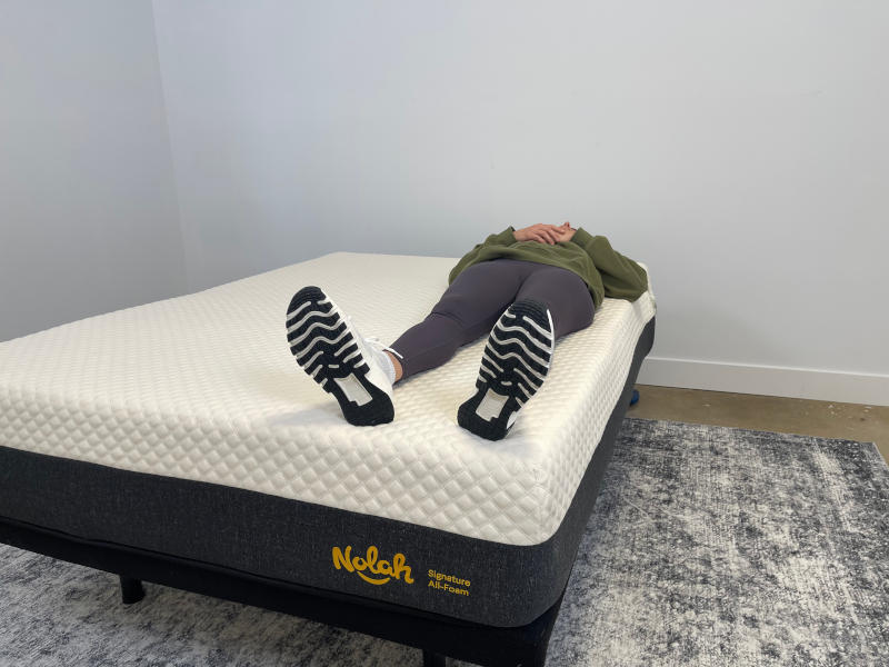 Our tester back-sleeping on the Nolah Signature Mattress