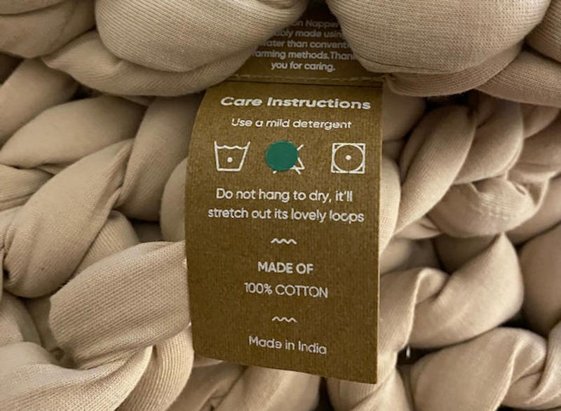 A close look at the care tag for a Bearaby Weighted Blanket
