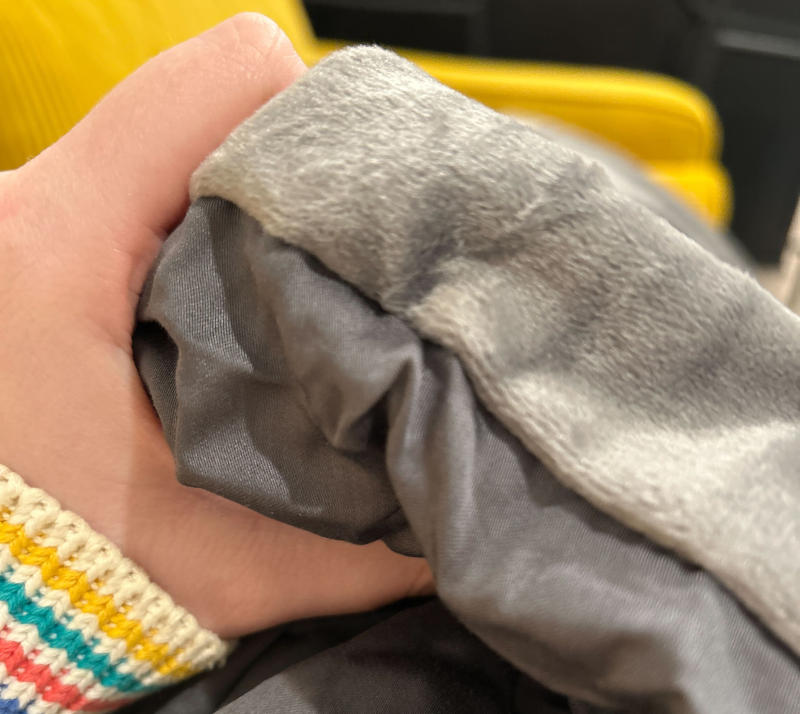 Our sleep expert feeling a gray Luxome weighted Blanket