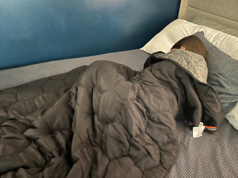 Our tester cozied up with the Layla Weighted Blanket