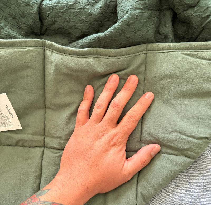 Our tester feels the inside of a Brooklinen Weighted Blanket
