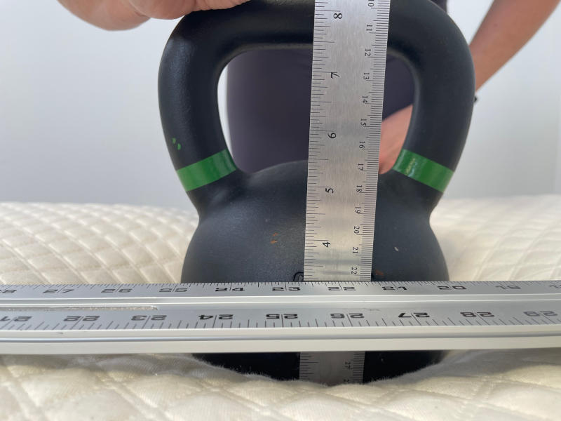 Our tester conducting a sinkage test on the Nolah Signature Mattress