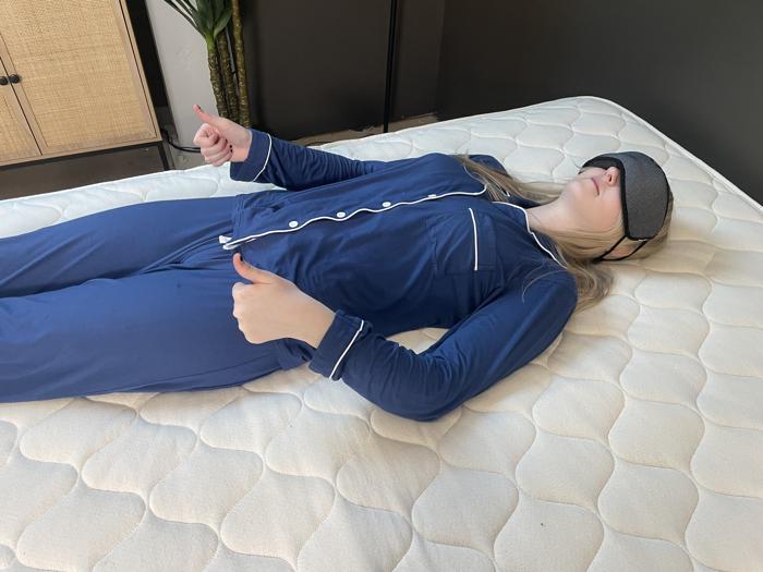 Our sleep expert Riley Otis conducting a motion isolation test on the WinkBed EcoCloud Hybrid
