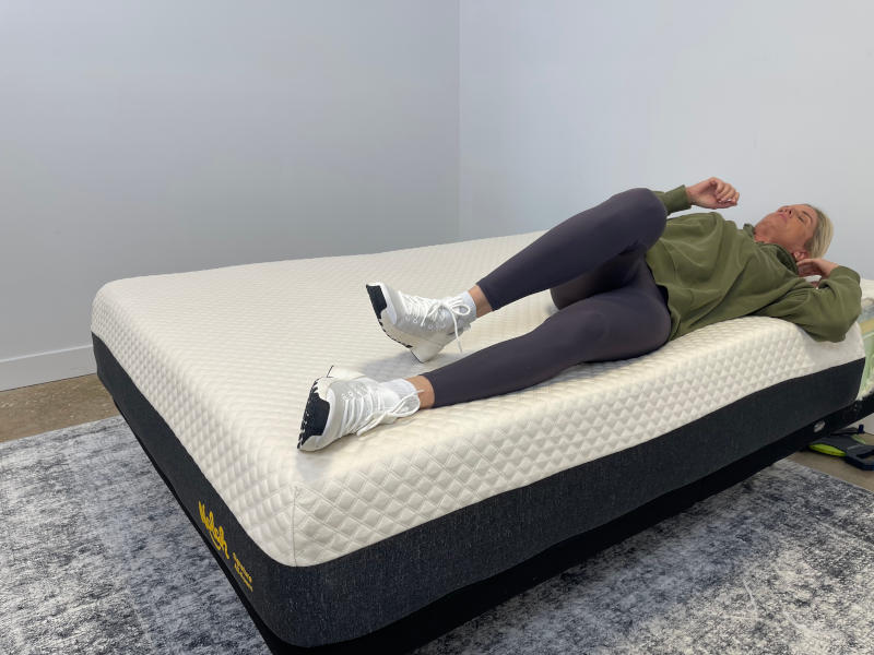 Our tester changing positions to assess the responsiveness of a Nolah Signature Mattress