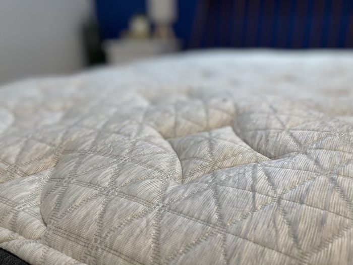 A closeup of the tufted cover of the Helix Dusk Luxe.